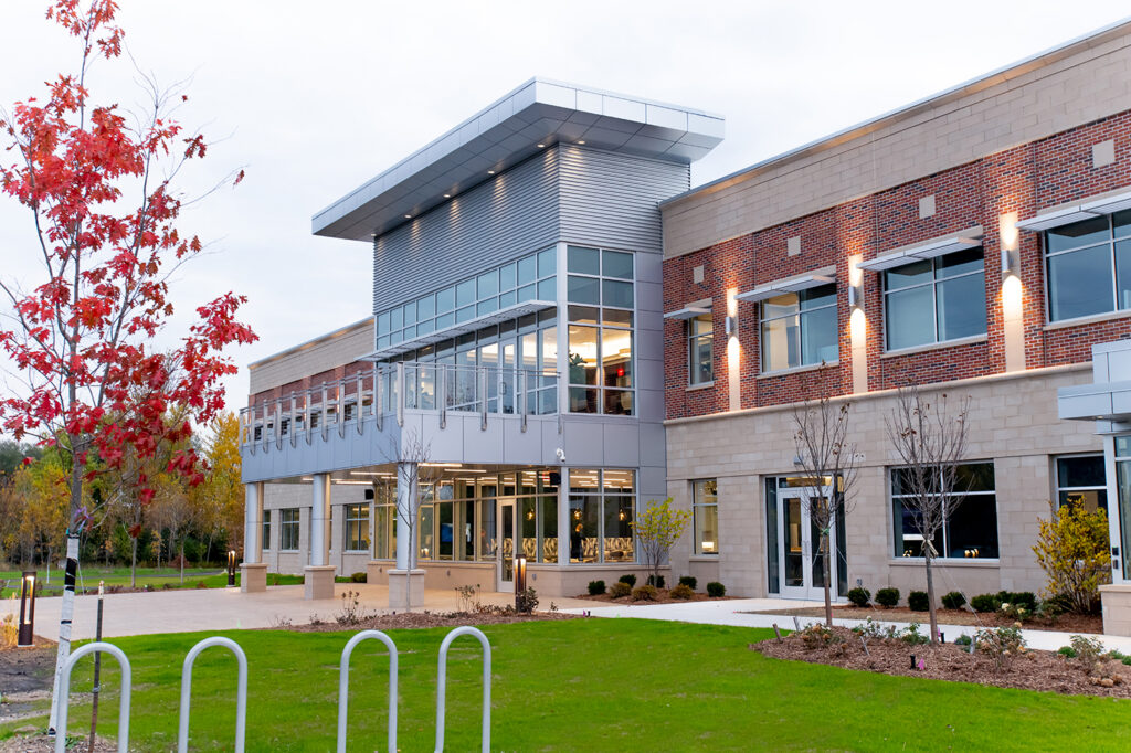 Exterior of the SET SEG building with illuminated lights and colorful fall colors on the trees