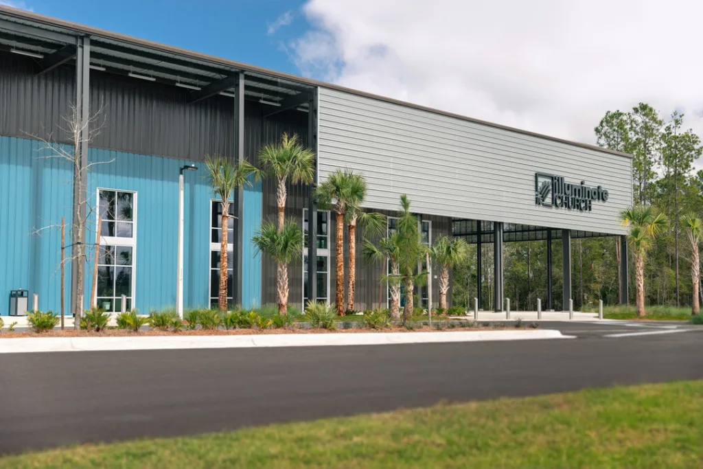 The exterior of the Illuminate Church highlighting the well-manicured landscaping of the project. 