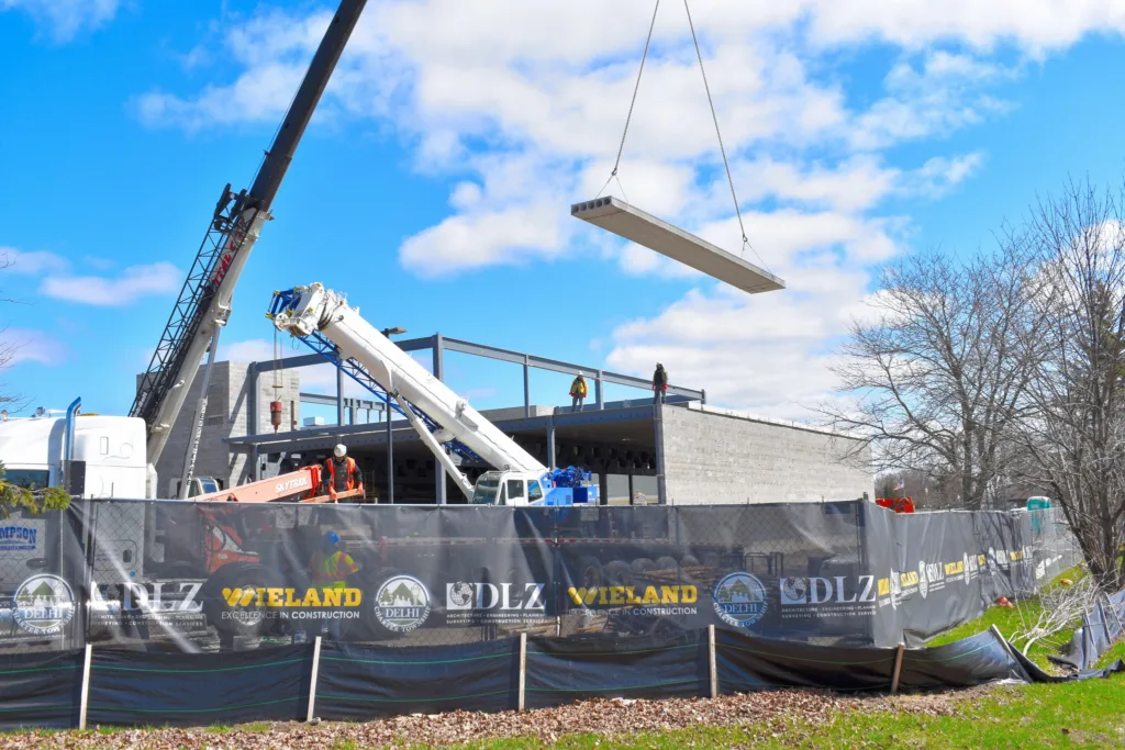 Precast concrete being put in place with a crane 