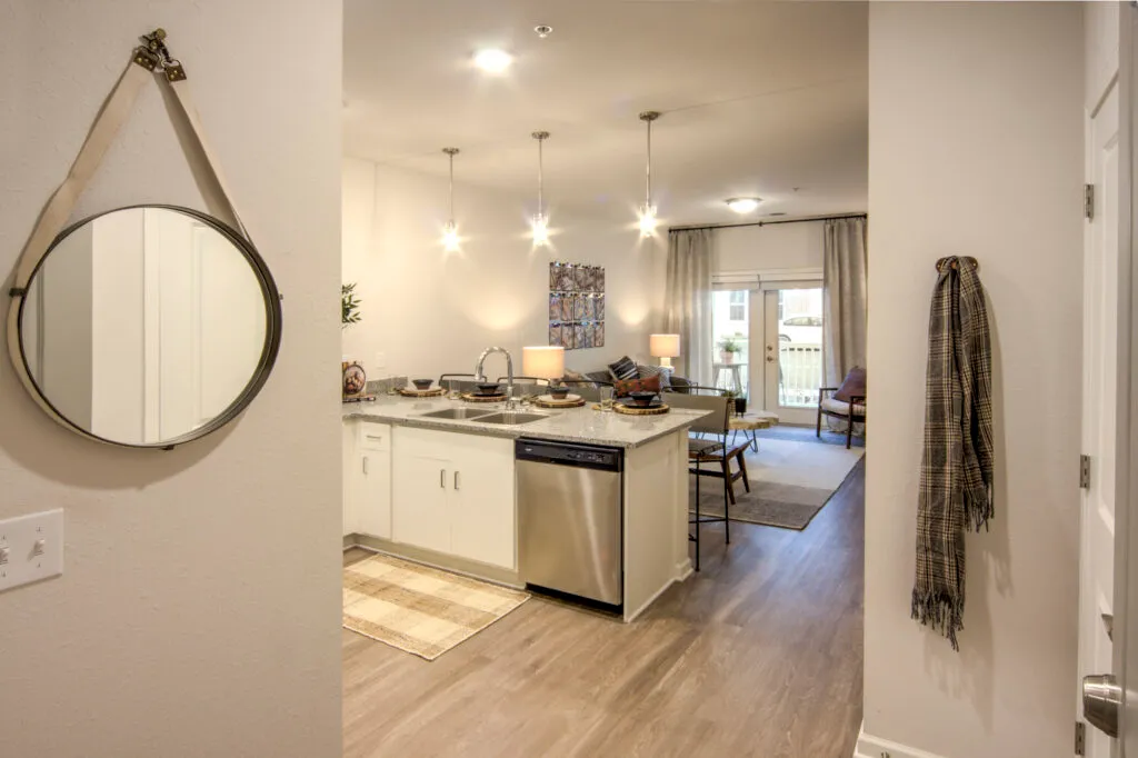 View of apartment kitchen and living area from front door