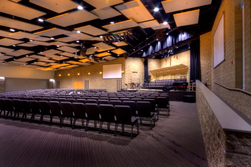 Chapel interior, including stage, choir seating, and projection screens