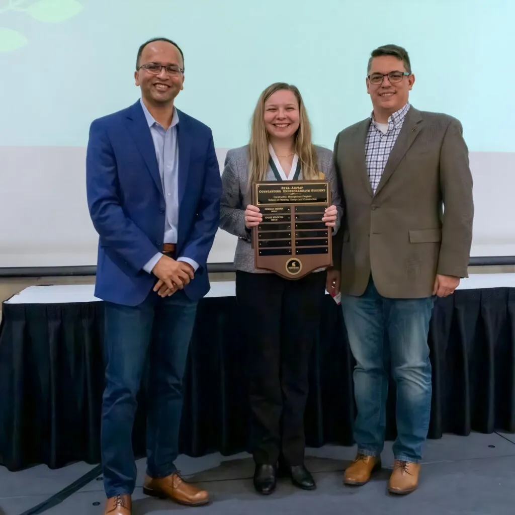 Chloe Schulten stands with their award