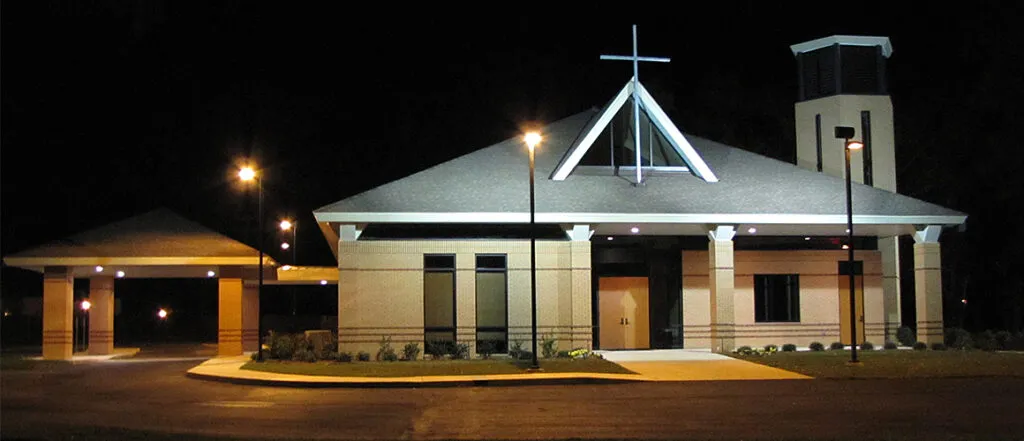 St. Pius X Roman Catholic Church exterior front entrance at night