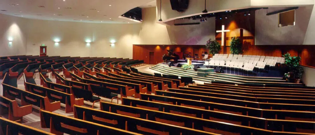 South Baptist Church chapel interior with view of pews, stage, and choir seating