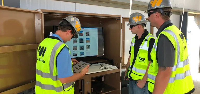 Three WIELAND team members review images on screen