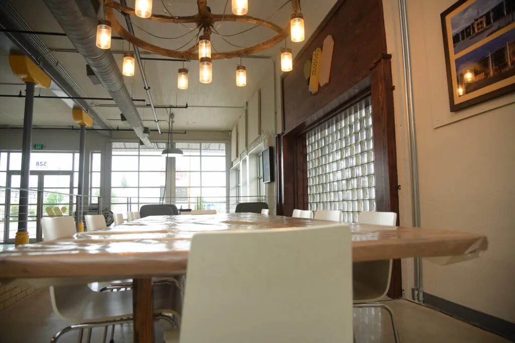 Close up of conference table in a large industrial-styled room at WIELAND.