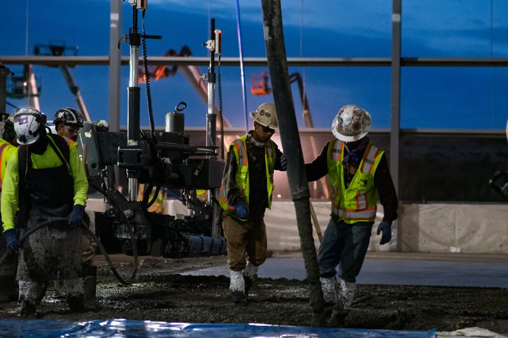 WIELAND team members fill in concrete at a jobsite