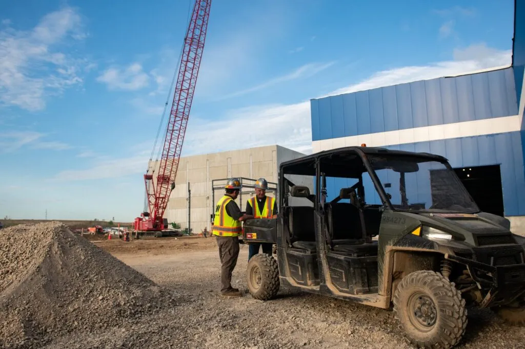 Wide view of construction site with heavy machinery and team members at work.