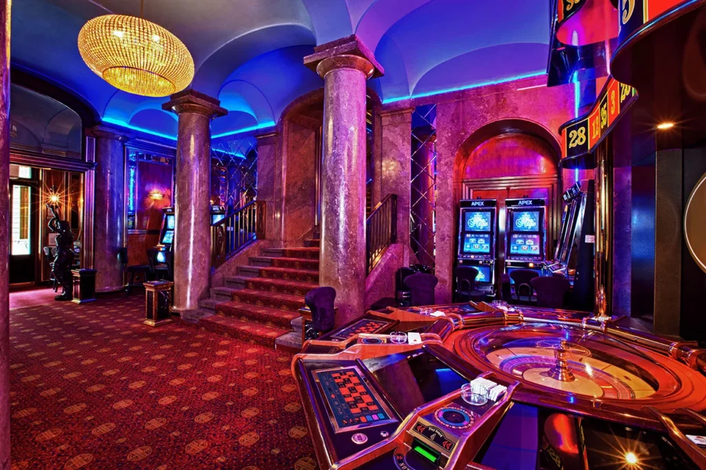 A casino room at Remington Park Turf featuring a roulette table and gaming area, bustling with players and excitement.