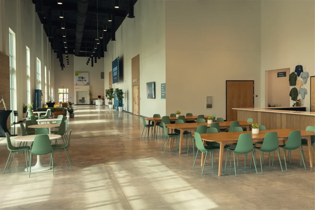 Large open space at Illuminate Church, Celebration, FL, with several tables and chairs set up for community events.