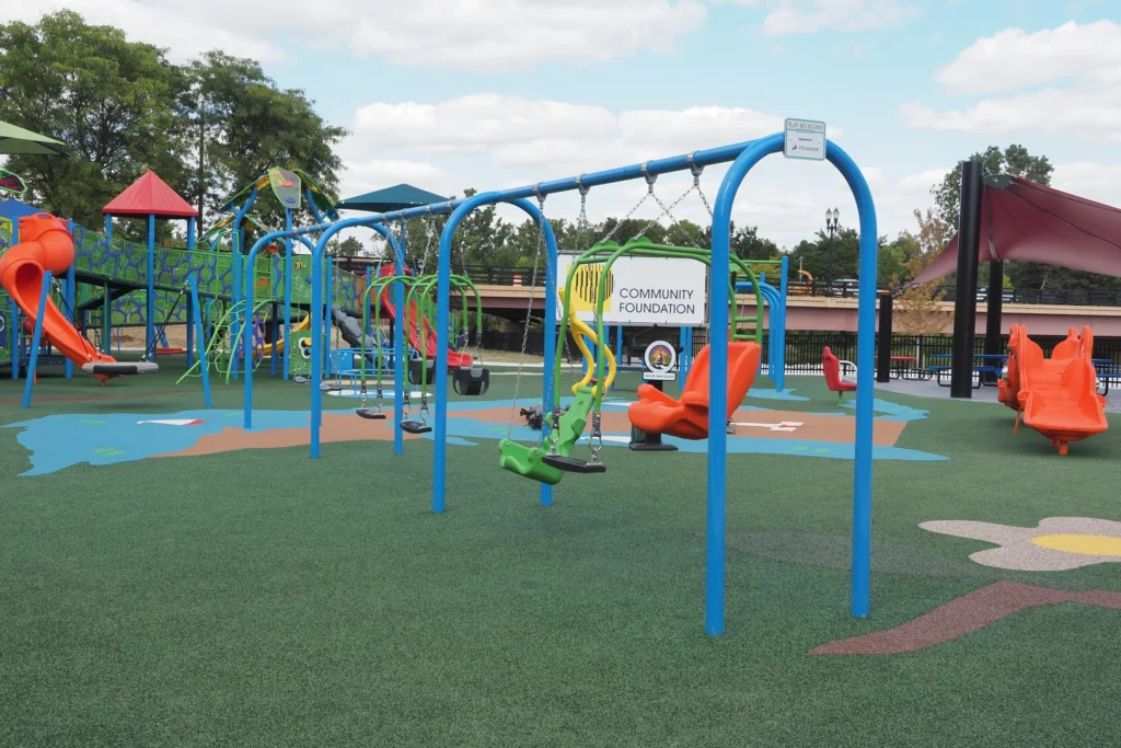 PlayMichigan playground in Lansing, MI, showcasing swings and slides for outdoor fun.