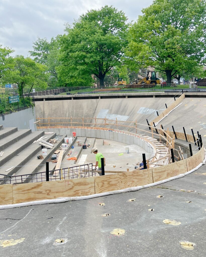 Construction worker sawing boards