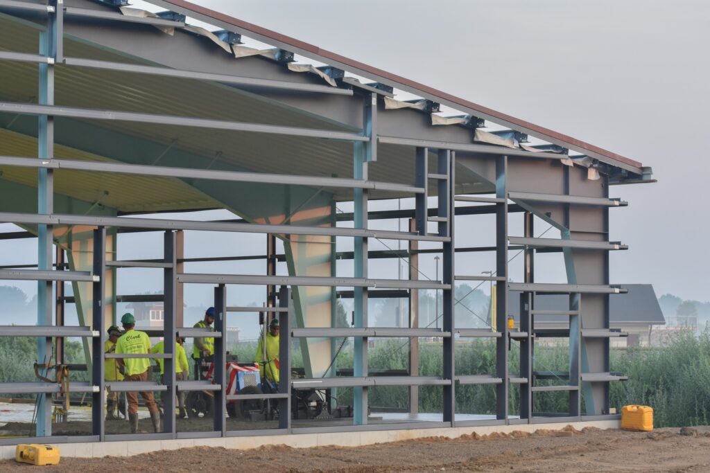 Construction workers pouring concrete on the inside of a building