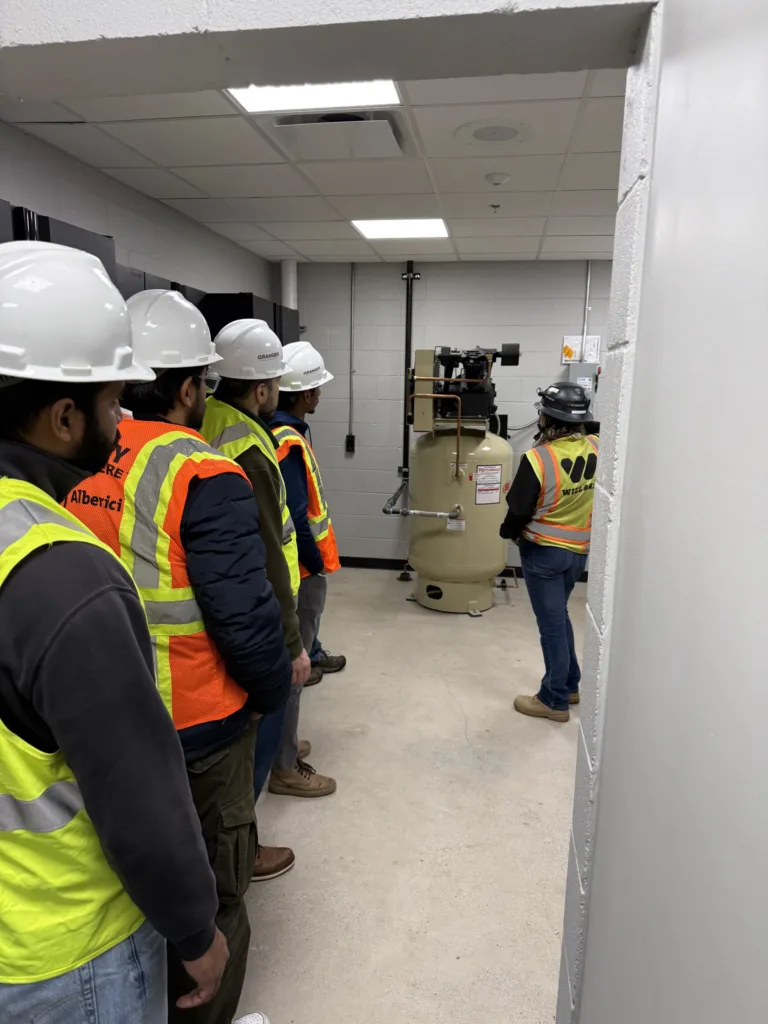 Group looking at the hot water heater in the Fire Department's basement. 