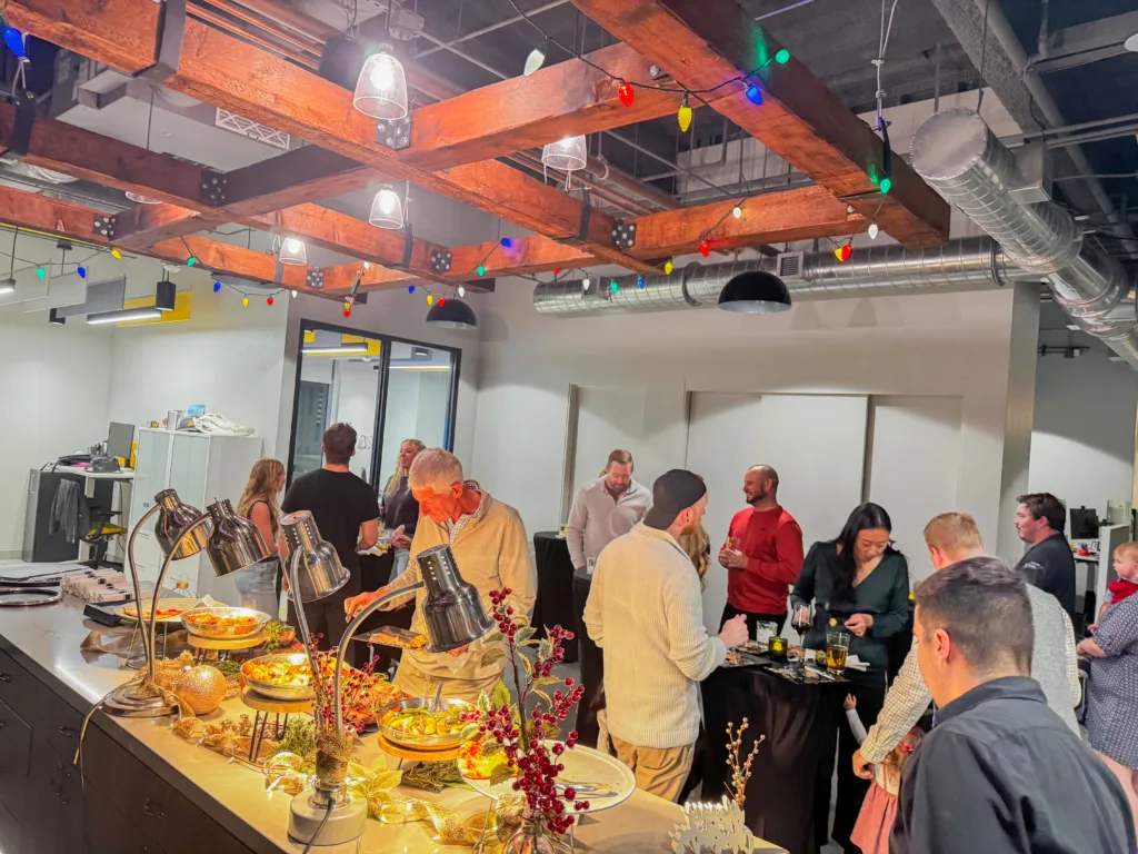 Florida office Christmas Party with everyone gathered for some food. 