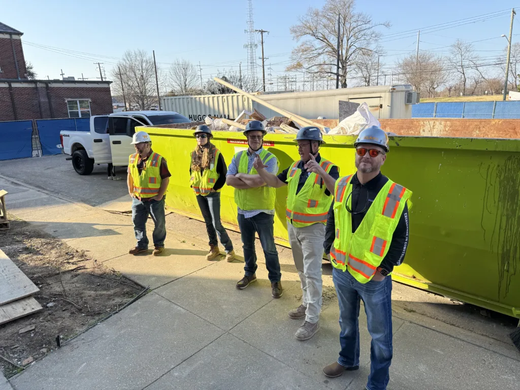 Group gathered on the outside of the building to view the ongoing construction. 