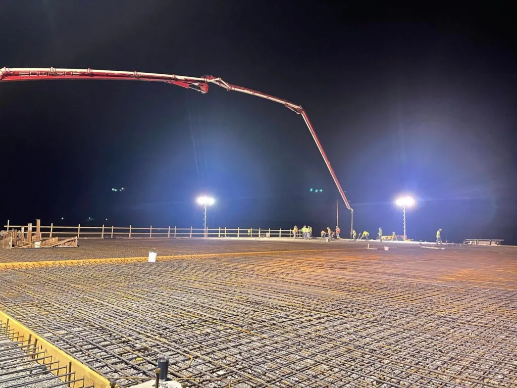 Extended pump truck delivering concrete 