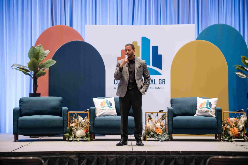 Man speaking at a conference in Grand Rapids