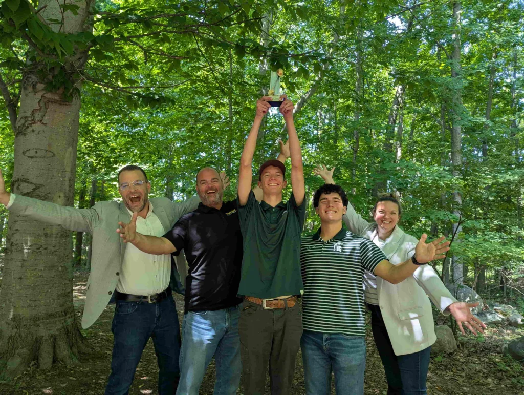 Group gathered and smiling for a photo with the award winning group. 