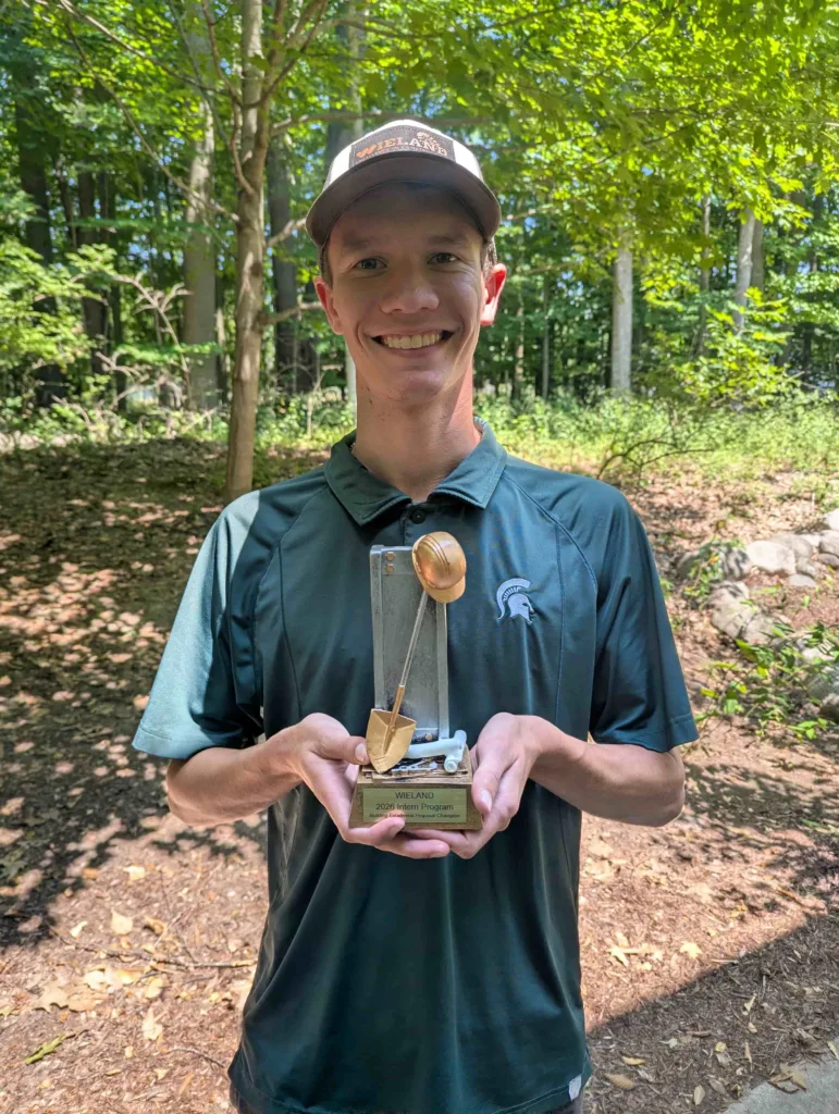 Picture of Chance Comley holding his 2026 Intern of Excellence award. 